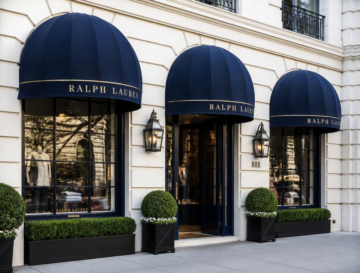 Row of navy dome awnings with gold lettering above boutique storefront windows